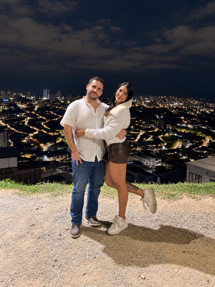 Gala y Alejandro abrazados con la ciudad iluminada de noche